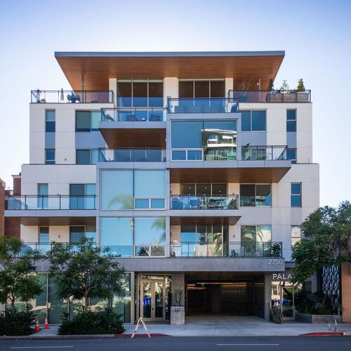 Modern residential building with integrated parking system access, spacious balconies, and high-quality architecture.