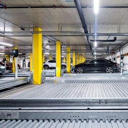 Front view of the parking systems with a car pulling in