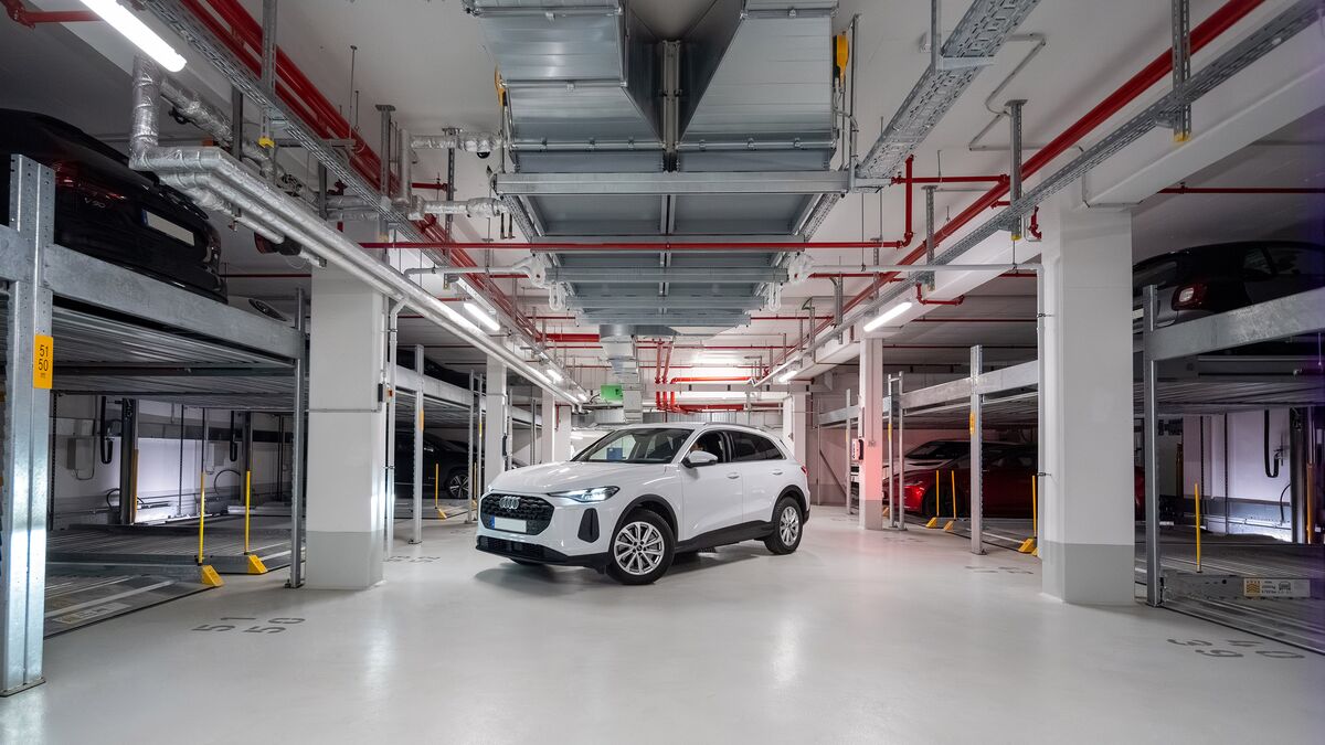 The car is parked in the aisle of the underground car park between two Combilift systems