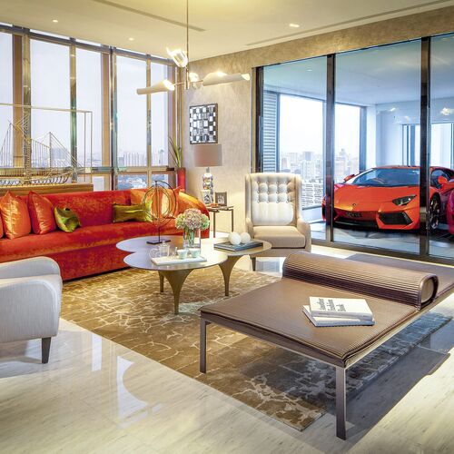 The living room of a flat, with the cars parked in the sky garage