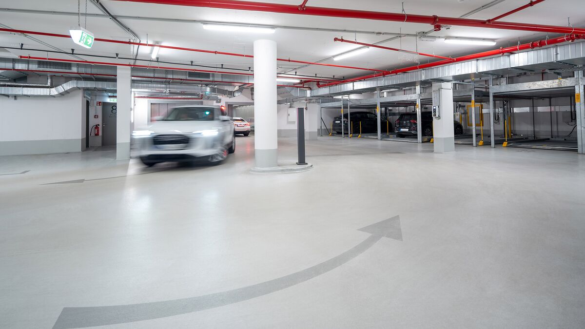 A car driving into the high-rise building’s underground car park