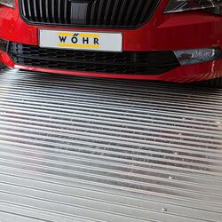 The car is parked on a parking slab