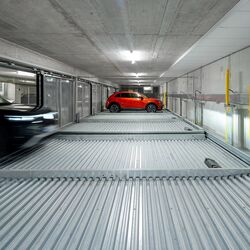 A car drives into the parking system
