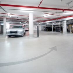 A car driving into the high-rise building’s underground car park