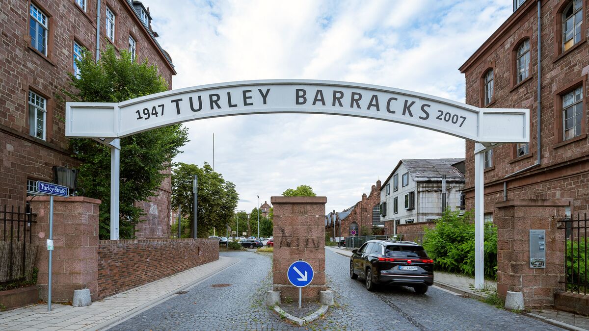 A car drives through an entrance gate